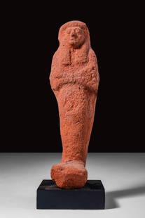 EGYPTIAN TERRACOTTA USHABTI: New Kingdom Ca. 1550 - 1069 BC. An Egyptian mummiform terracotta ushabti with a striated wig and arms folded at the chest. The facial features are visible. Reviewed by Simone Musso, consultant