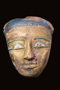 EGYPTIAN GILT WOODEN MASK WITH INLAID EYES: Late Period, Ca. 664 - 332 BC. A large, finely carved wooden sarcophagus mask. It is carved from cedar and covered with gilt gesso. The idealised facial features include a long, thin nose, pursed