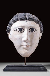 EGYPTIAN PAINTED PLASTER MASK: Roman Period, Ca. AD 100 - 200. A funerary plaster mask of a male face made from layers of plaster or stucco upon papyrus or linen, and painted with bold features in black and white. The dramatic