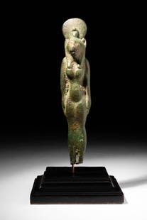 EGYPTIAN BRONZE STATUETTE OF SEKHMET: Late Period, Ca. 664 - 332 BC.A bronze statuette of the striding Sekhmet with her left foot forward. The lion-headed goddess wears a tripartite wig and a tight-fitting dress which reaches to the