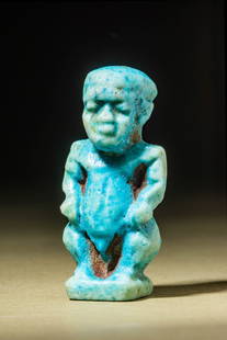 EGYPTIAN FAIENCE PATAIKOS AMULET: New Kingdom, Ca. 1550 - 1069 BC.An intriguing depiction of the god Pataikos, the bow-legged dwarf deity. The amulet is mould made from faience and covered in a lustrous blue-green glaze. He stands