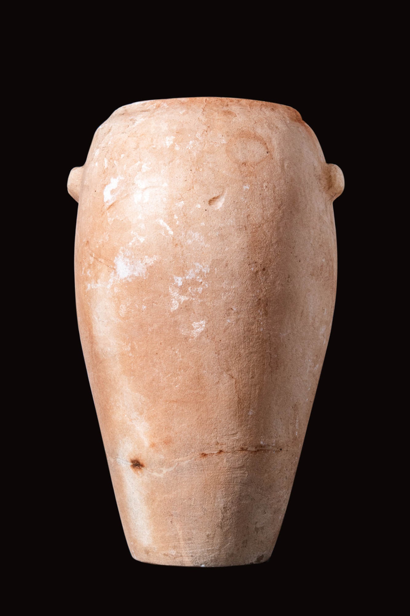 EGYPTIAN ALABASTER TALL VESSEL: Old Kingdom, Ca. 2640 - 2150 BC. An alabaster alabastron carved with a piriform body connected to a short cylindrical neck. The upper body of the vessel has two short handles. For similar see: The Met