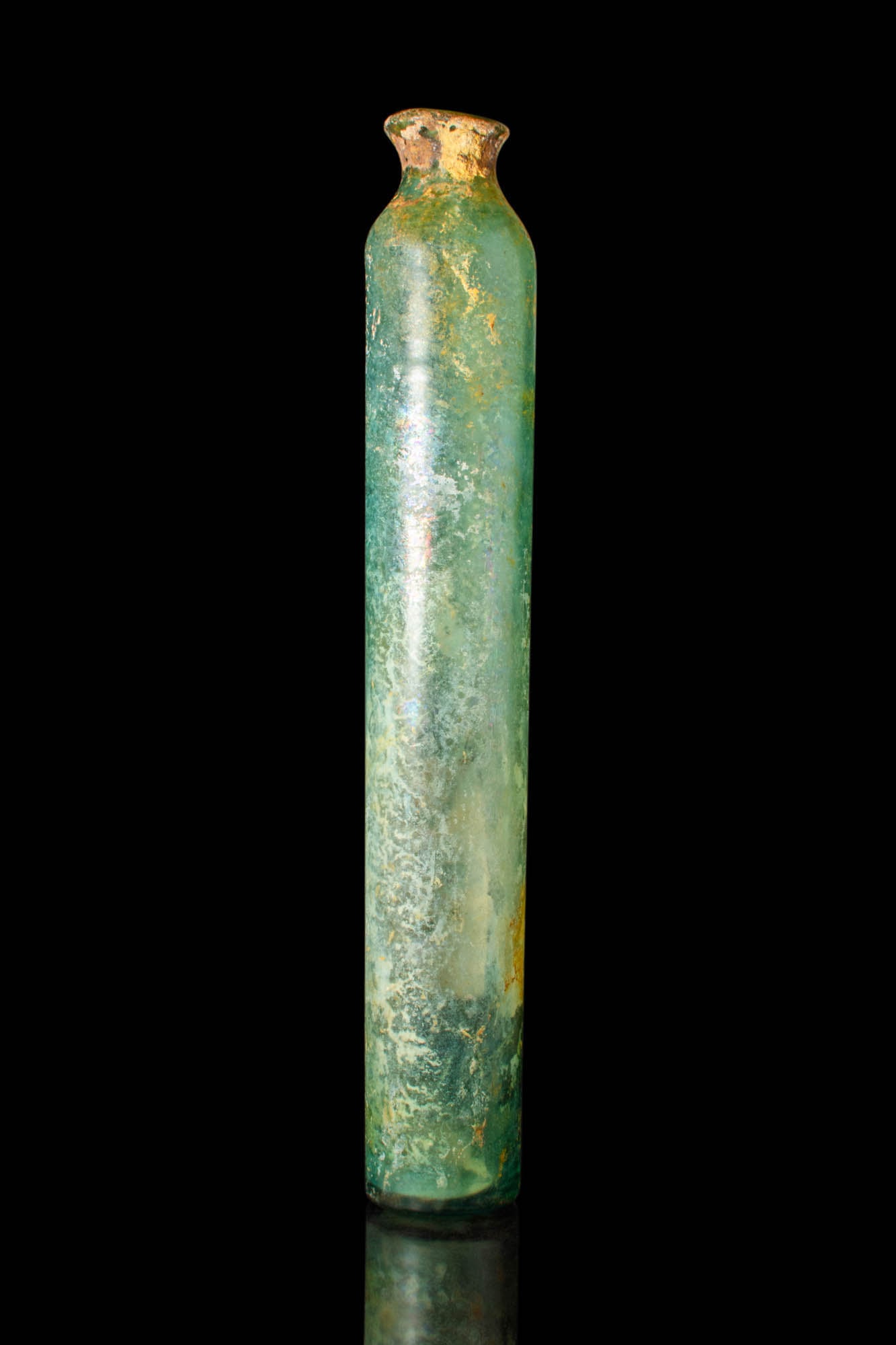 ROMAN TALL GLASS JAR: Ca. 100 BC - AD 100.A glass jar with an elongated tubular body, a short funnel-shaped opening, and a flat base.Size: 350mm x 60mm; Weight: 505gProvenance: Property of an Oxfordshire art professional;