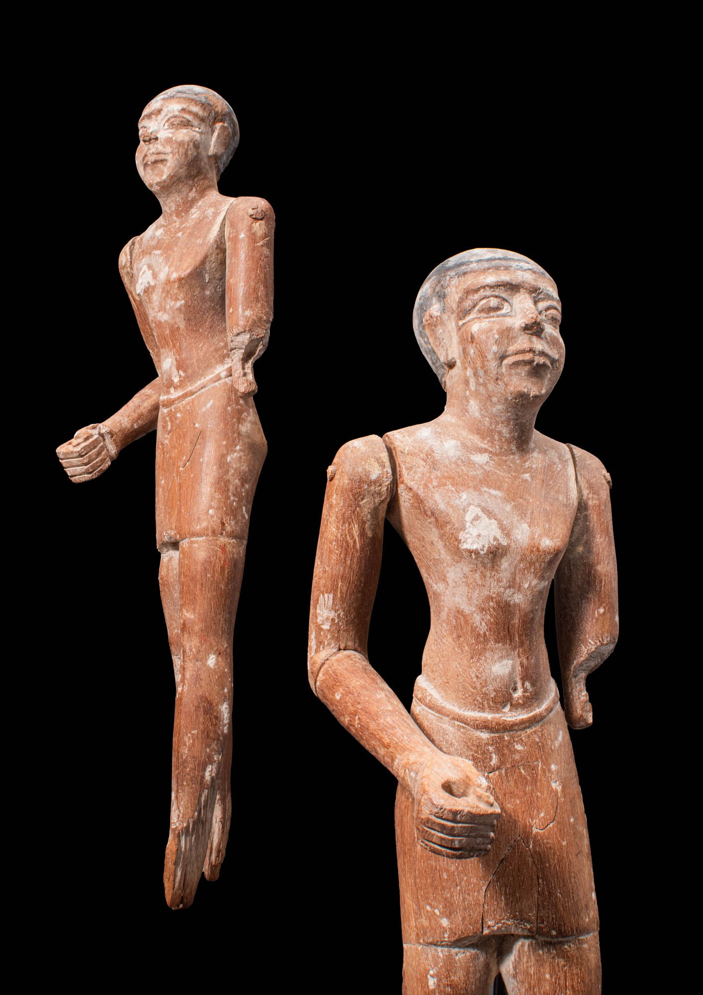 HUGE EGYPTIAN WOODEN STATUETTE OF A MAN: New Kingdom, Ca. 1550 - 1069 BC.An Egyptian carved wooden male, perhaps once a servant figure in a tomb. The man presents in a striding pose with his front left leg extended. Wooden sculptures like th