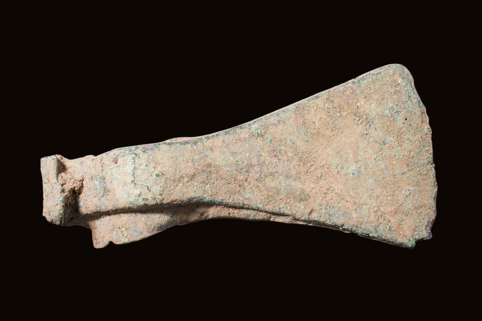 BRONZE AGE BRONZE AXE HEAD: Ca. 2nd - 1st millennium BC.A bronze axe head with a tubular shaft and a long flaring blade. Bronze axes were essential tools and weapons, widely used from around 3300 to 1200 BC. Crafted from an allo