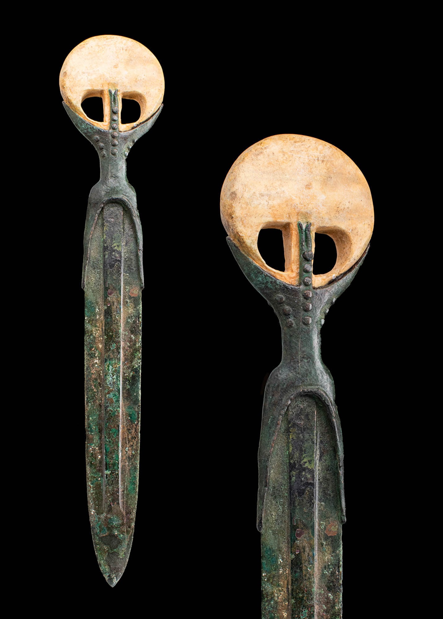 EGYPTIAN BRONZE DAGGER WITH A POMMEL MADE FROM HIPPOPOTAMUS TOOTH: Middle Kingdom, 12th - 15th Dynasty, Ca. 1991-1640 BC. A bronze dagger with a pointed blade and a raised midrib, inserted into the separately cast hilt and attached by rivets. The hilt, with an arched