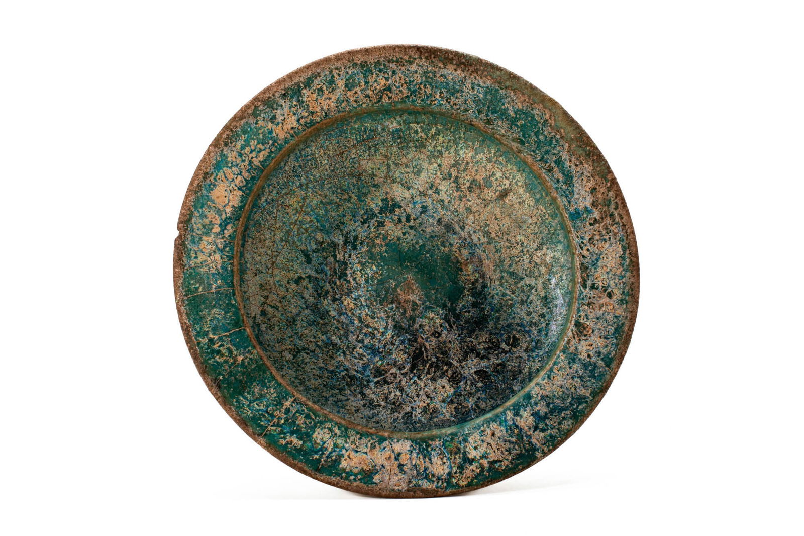 A TURQUOISE SMALL-FOOTED LUSTREWARE POTTERY BOWL, POSSIBLY SYRIA OR KASHAN: Probably Syria, or Iran, Ca. AD 1200 - 1300 . A pottery bowl of circular form, the deep basin set on four rounded feet, the wide everted rim gently sloping inward to a recessed well, the entire surfac