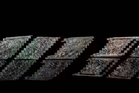 COLLECTION OF BYZANTINE BRONZE BELT FITTINGS: Ca. AD 900 - 1000. A collection of four bronze belt fittings, each rectangular in form and cast in low relief. The pieces depict a range of figural and zoomorphic motifs, including winged and horned q