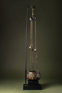 BYZANTINE BRONZE AND IRON CENSER DECORATED WITH SCENES FROM THE LIFE OF THE VIRGIN: Ca. AD 600 - 700. A bronze censer with a hemispherical bowl, suspended by three chains connected to a suspension aperture. The bowl is adorned with a continuous relief depicting scenes from the life o