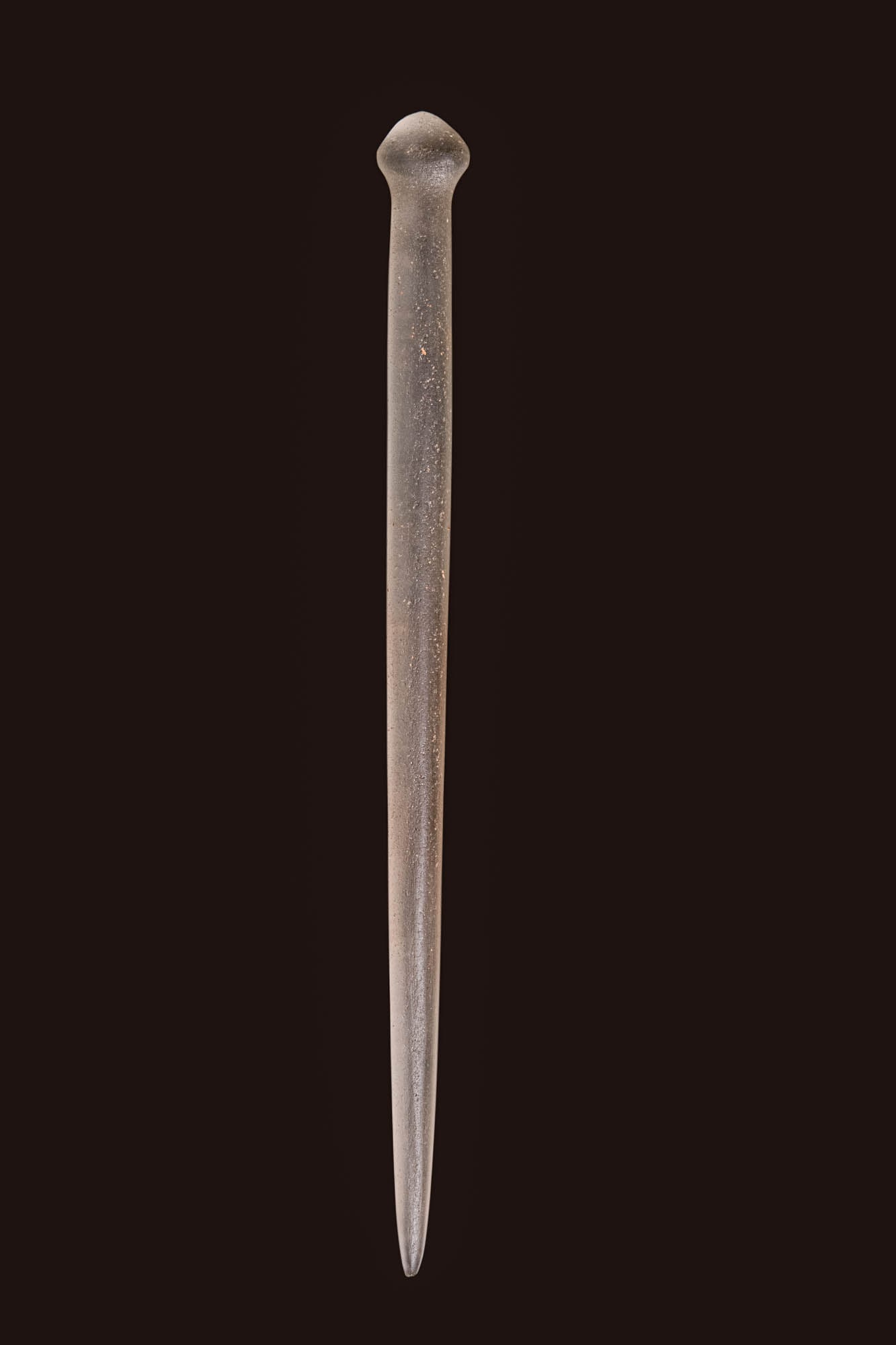 EGYPTIAN QUARTZ RITUAL ROD: Ca. 1550 - 664 BC. A long rod carved from translucent quartz, tapering gradually to a pointed end. The opposite end is rounded and bulbous, forming a distinct terminal. Reviewed by Simone Musso, consu