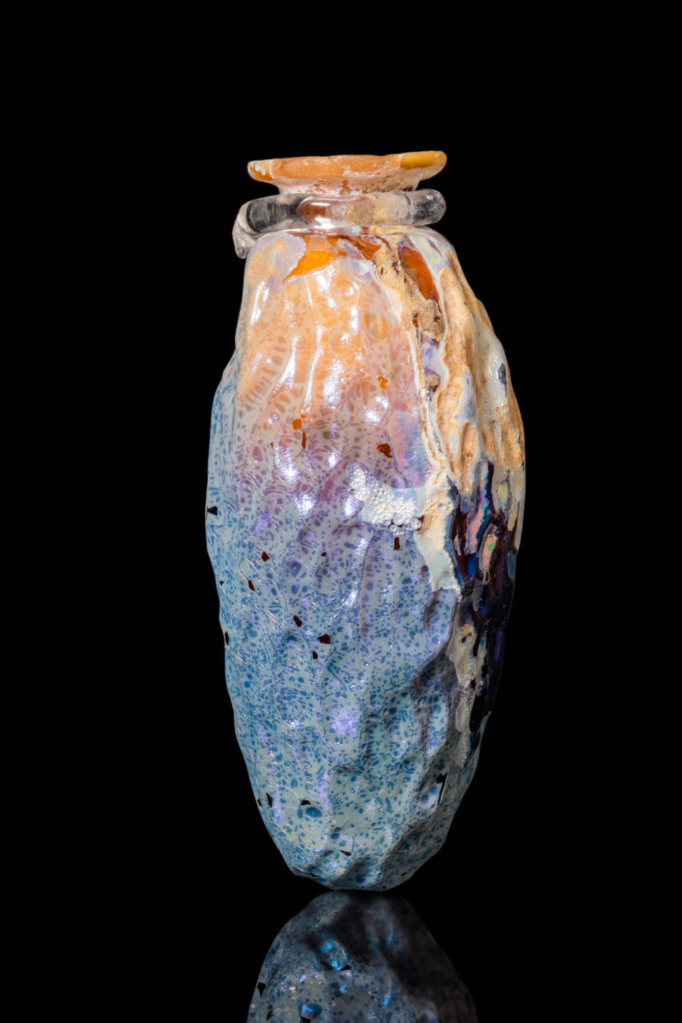 ROMAN GLASS DATE-SHAPED UNGUENTARIUM: Ca. 100 BC - AD 100. A mould-made glass unguentarium in the shape of a date, with an elongated, ribbed body tapering towards the base and a short neck with an everted rim.For similar see: The Metropol