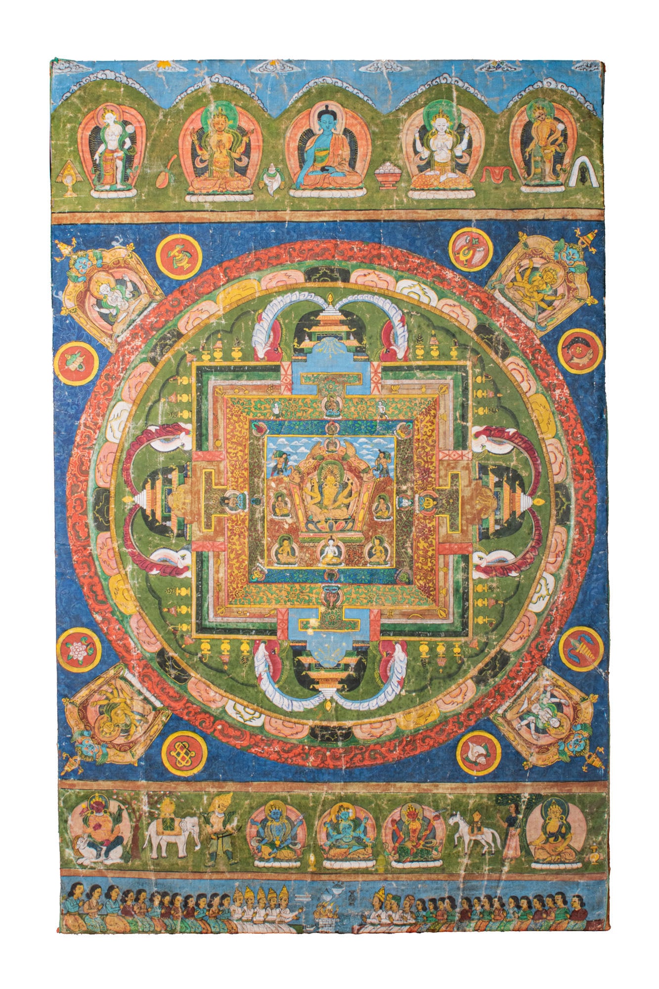 NEPALESE TANGKA OF MANDALA: Ca. AD 1800 - 1900. An intricate Nepalese tangka depicting a mandala, likely representing a celestial palace with concentric rings of symbolic architecture and figures. The central deity is surrounded