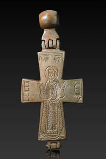 BYZANTINE BRONZE ENKOLPION WITH SAINT: Ca. AD 950 - 1100. A hinged bronze cross (enkolpion) with a saint in orant pose on one side, dressed in a long robe with hands raised. The arms of the cross bear incised detailing, and a suspension lo