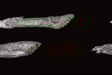 PAIR OF SILVER AND BRONZE VIKING AGE BELT STRAP ENDS: Ca. AD 400 - 600. A pair of belt strap ends composed of a bronze frame with silver inlays, decorated with incised spirals and vegetal scrolls. One end bears two rivet holes, while the opposite end ter