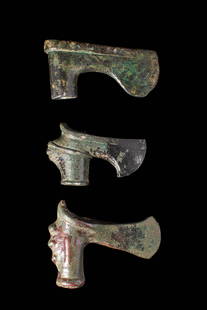 COLLECTION OF EARLY GREEK / BRONZE AGE AXE HEADS: Ca. 1200 - 900. A collection of three socketed bronze axe heads. The upper example has a sharply defined blade and a plain cylindrical socket. The middle axe features a prominent rib on its shaft. The