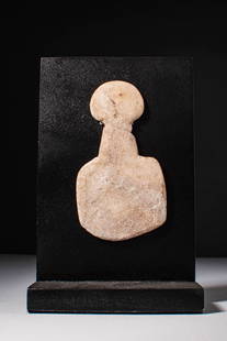 ANATOLIAN KUSURA TYPE MARBLE IDOL: Ca. 3000 - 2500 BC. A schematic marble idol with a broad, circular head, narrow neck, and trapezoidal lower body with a rounded base. Mounted on a modern display stand.For similar see: Sotheby's, The