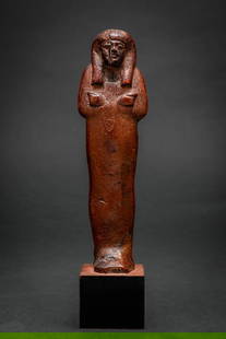 SUPERB EGYPTIAN WOODEN USHABTI: New Kingdom, Ca. 1550 - 1069 BC. A wooden ushabti figure of mummiform type, with the arms crossed over the chest and the hands emerging to hold agricultural tools. The head is framed by a tripartite w