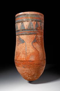 EGYPTIAN POLYCHROME TERRACOTTA VASE WITH LOTUS BLOOMS, WAS-SCEPTRE AND ANKH: New Kingdom, Ca. 1550 - 1069 BC. A terracotta vase with an elongated ovoid body tapering towards a pointed base. The surface is painted in blue, black, and red pigments on a reddish-orange ground. The