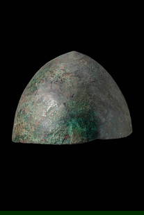 ETRUSCAN BRONZE HELMET: Ca. 400 - 300 BC. A hemispherical bronze helmet hammered from a single sheet, with a smooth domed crown.For similar see: Catalogo generale dei Beni culturali, Ente Competente S162, Cat. IA IX.Size: 21