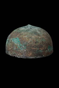 ETRUSCAN BRONZE HELMET: Ca. 400 - 300 BC. A bronze helmet formed from a single hammered sheet, shaped into a low hemispherical dome with a central apex.Size: 175mm x 100mm; Weight: 515gProvenance: Private London collection,