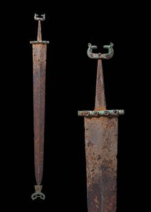 SCYTHIAN IRON SWORD WITH BRONZE GUARD, POMMEL WITH FACING GRYPHONS AND CHAPE: Ca. 600 - 500 BC. An iron blade with a lenticular section and prominent midrib, tapering to a point. The rectangular bronze guard is decorated with four circular cells, each inset with a red cabochon.