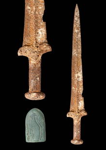 SCYTHIAN ACINANES IRON DAGGER WITH GREEN STONE SCABBARD POINT: Ca. 500 - 400 BC. A lengthy forged iron dagger featuring a wide, flat handle, a curved semicircular pommel, and a broad guard. The long, hammered iron blade tapers to a sharp point, and the stone scab