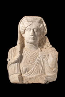 EXCEPTIONAL PALMYRIAN RELIEF OF A LADY: Near East, Ca. 1st - 3rd century AD. A limestone relief depicting a female figure in frontal view. The face has large almond-shaped eyes with incised circles marking the irises and pupils, slightly ar