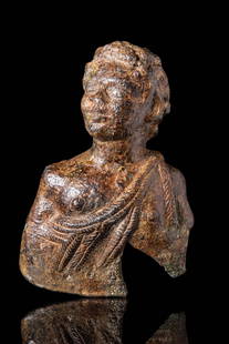 MASSIVE ROMAN BRONZE YOUNG SATYR APPLIQUE: Ca. AD 100 - 300. A bronze applique in the form of a youthful male bust with stylised facial features, short curly hair, and defined pectorals. The figure is draped with a garment rendered in raised,
