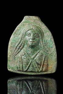 LARGE ROMAN BRONZE PLAQUE WITH VENUS: Ca. AD 1 - 200. A flat, arched plaque with a relief bust of a female deity in frontal view. She is shown with centrally parted hair arranged in long, ribbed strands falling over her shoulders. The gar