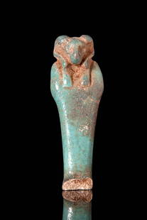 EGYPTIAN FAIENCE AMULET OF MUMMIFORM KHNUM: Roman Period, Ca. 30 BC - AD 200. A turquoise faience amulet depicting the god Khnum in mummiform posture, with arms crossed tightly over the chest and legs fused into a tapering base. The head is ren