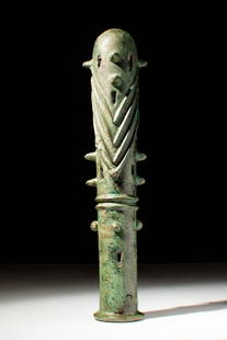 EARLY GREEK/ BRONZE AGE MACE HEAD WITH GEOMETRIC MOTIF: Ca. 900 - 800 BC. A cast bronze tubular mace head with raised chevron motifs arranged in vertical registers between protruding knobs. Cut-outs pierce the body in a symmetrical arrangement, and the upp