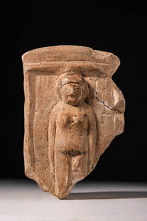 EGYPTIAN STONE RELIEF DEPICTING A WOMAN: Late Period, Ca. 664 - 332 BC. A fragment of a stone relief depicting a standing female figure within a recessed niche with a raised border. She is shown frontally, with clearly outlined facial featur