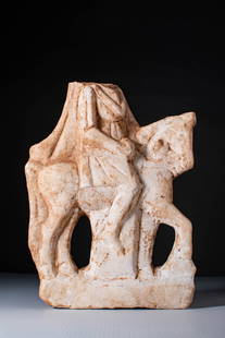 HELLENISTIC MARBLE STATUE OF RIDER ON HORSE: Ca. 200 BC. A marble relief depicting a rider on horseback. The rider, seated in profile on a slender horse with a slightly raised head, is draped in a mantle that falls down the back. The head is mis