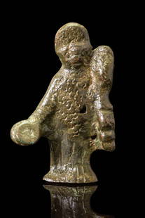 GALLO-ROMAN BRONZE GODDESS: Ca. AD 1 - 200. A cast bronze figurine depicted standing and wearing a long robe and a textured mantle. The right arm extends forward, holding a round object. The head is crowned with an arched headdr