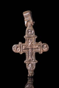 MEDIEVAL BRONZE ENKOLPION CROSS WITH CHRIST AND SAINTS: Ca. AD 900 - 1100A Medieval bronze Enkolpion composed of two halves. It is decorated with crucified Christ and saints depicted on the top of the arms on side A. On side B, there is a depiction of the