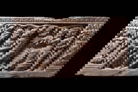 GANDHARAN STONE PANEL: Ca. AD 2-3rd Century. A Gandharan narrative relief panel, possibly depicting the scene of the Birth of Siddhartha. The scene involves a female figure at far left in a graceful posture, multiple male f