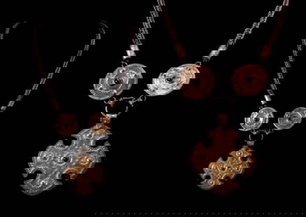 MEROVINGIAN SILVER-GILT BISHOP'S NECKLACE WITH CROSS PENDANT: Ca. AD 400 - 600. A silver-gilt necklace comprising a woven chain terminating in cylindrical collars and joined to two large discoid elements, each with a central garnet cabochon and punched