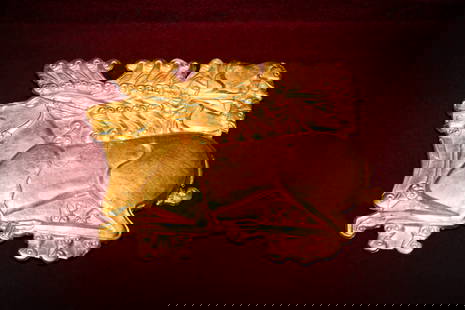 EXTRAORDINARY SCYTHIAN HIGH KARAT GOLD STAG PLAQUE: Ca. 500 - 300 BC. A gold plaque in the shape of a recumbent stag shown in profile to the left, the legs folded beneath the body and the head raised. Above the animal, two rows of coiled volutes