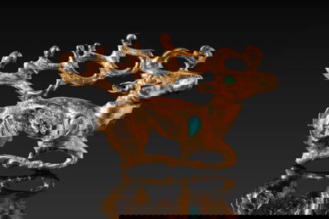 STUNNING SCYTHIAN GOLD AND TURQUOISE BELT FITTING DEPICTING HORNED STAG: Ca. 400 - 100 BC. A gold belt fitting in the form of a recumbent stag with exaggerated, branching antlers extending along the back. The body is ornamented with turquoise inserts set into recessed