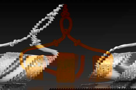 BACTRIAN HIGH KARAT GOLD PENDANT WITH LARGE AGATE BEAD: Ca. 1300 - 900 BC. A barrel-shaped banded agate bead encircled by three gold bands decorated with punched dots and herringbone motifs, set within a gold mount with a suspension loop formed of arched