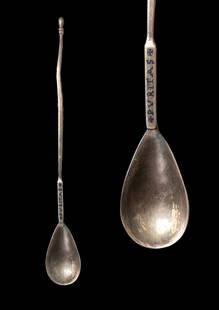BYZANTINE SILVER AND NIELLO SPOON WITH INSCRIPTION 'PVRITAS': Ca. AD 500 - 600. A silver spoon with an elongated handle ending in a rounded finial and a flat section inscribed 'PVRITAS' in niello, flanked by cross-shaped marks. The handle descends at a sharp