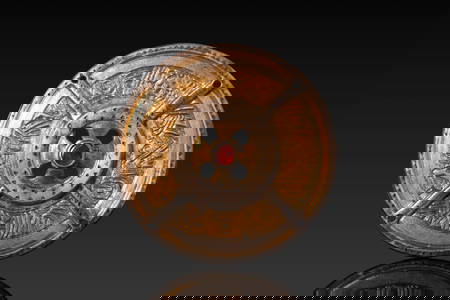 MEROVINGIAN OR SAXON SILVER-GILT APPLIQUÉ WITH CENTRAL RED GARNET