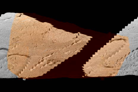 EGYPTIAN SANDSTONE RELIEF WITH PRIESTS: Amarna Period, Ca. 1353 - 1336 BC. A sandstone relief carved in sunk relief with four shaven-headed male heads set close together and shown in profile to the left, each with a large, rounded cranium,