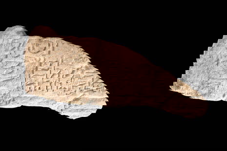 EGYPTIAN FRAGMENT OF SANDSTONE FUNERARY STELA: XXV Dynasty 747-664 BC. An Egyptian fragment of a funerary stela. This is likely the second register of the stela: the offerings for the deceased and part of his son's face performing funerary