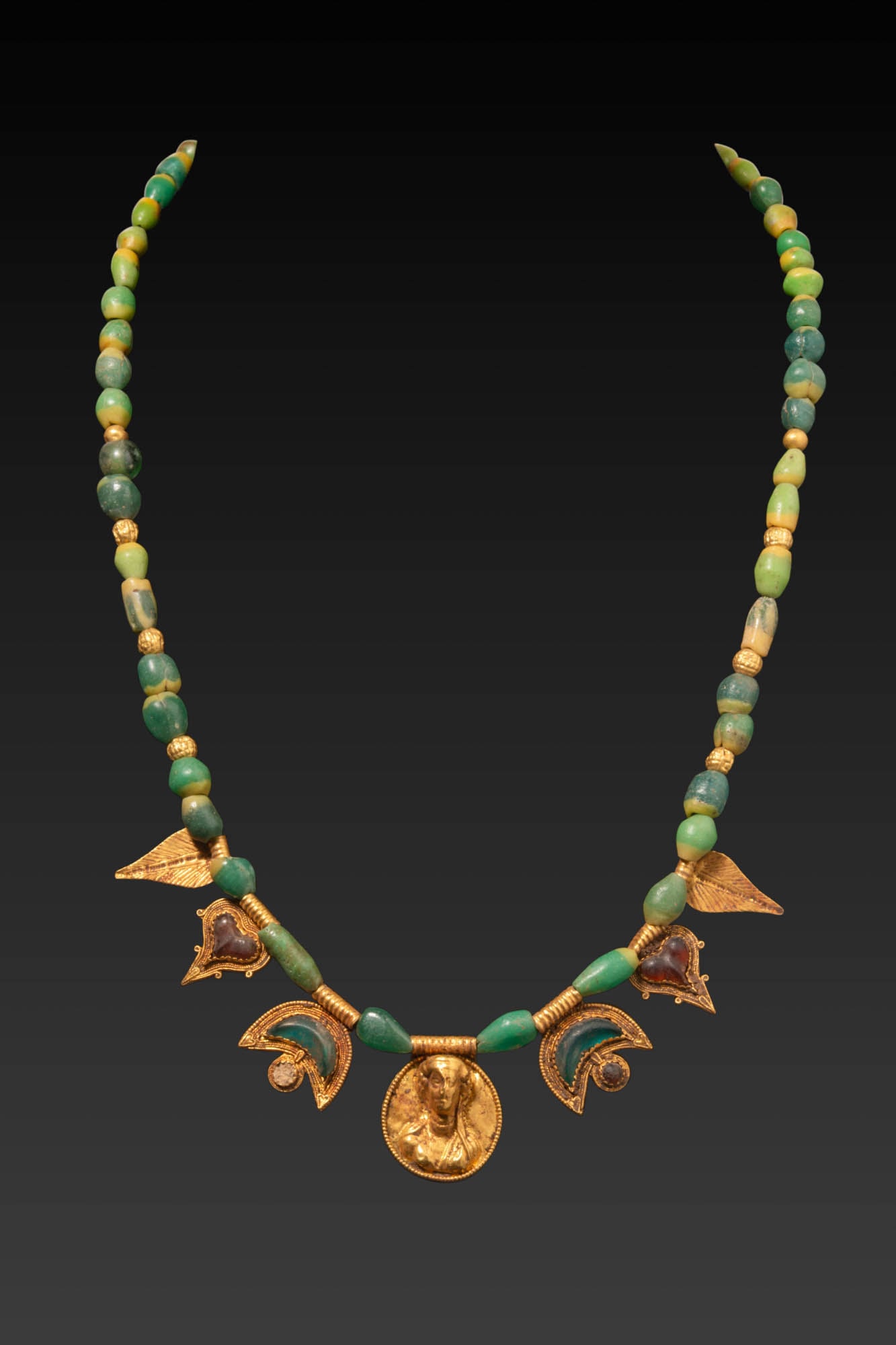 HELLENISTIC HIGH KARAT GOLD, CARNELIAN AND GLASS NECKLACE WITH CENTRAL PORTRAIT MEDALLION (1 of 4)