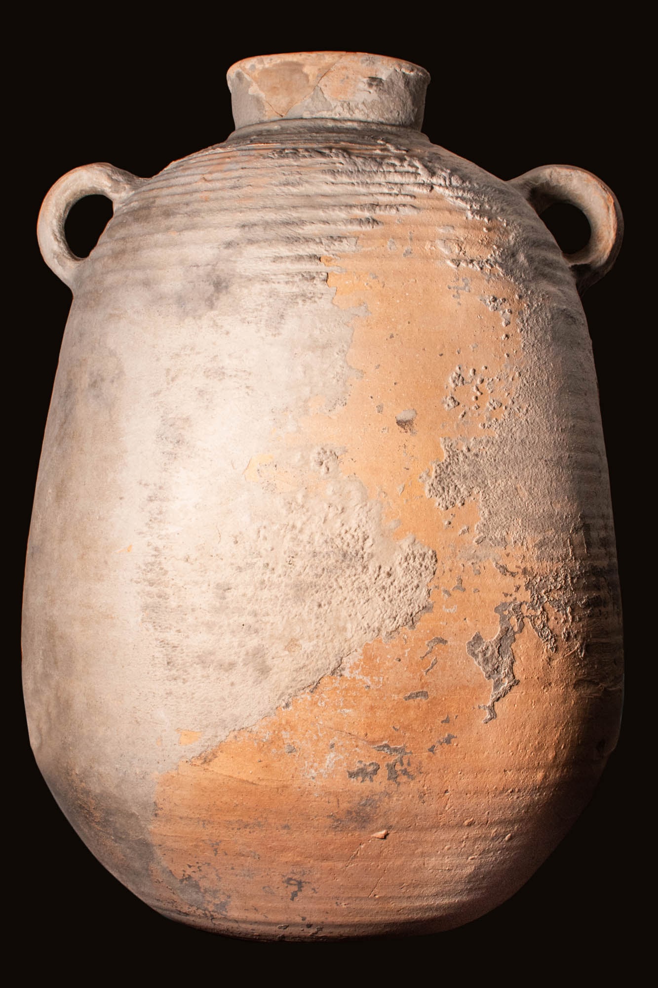 GREEK HELLENISTIC STORAGE AMPHORA: Ca. 400 - 300 BC. A large ceramic storage vessel with a cylindrical body and rounded base. Size: 450mm x 300mm; Weight: 3.7kg Provenance: Private UK collection; acquired pre-2000.