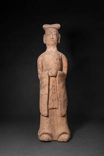 CHINESE TERRACOTTA STANDING COURT ATTENDANT - TL TESTED: Northern Wei Dynasty, Ca. AD 386 - 534. A court attendant figure modelled standing upright with hands clasped at the chest, dressed in long, flowing robes falling in soft vertical folds to the feet, t