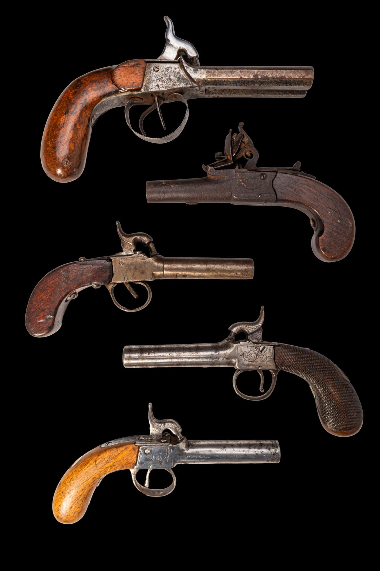 COLLECTION OF FIVE POCKET PISTOLS: Ca. 19th Century AD. A lot of five pocket pistols, all of which have proof-marks to the underside of the barrel. The first gun is a rare double-barrelled example, the second is the only flintlock of t
