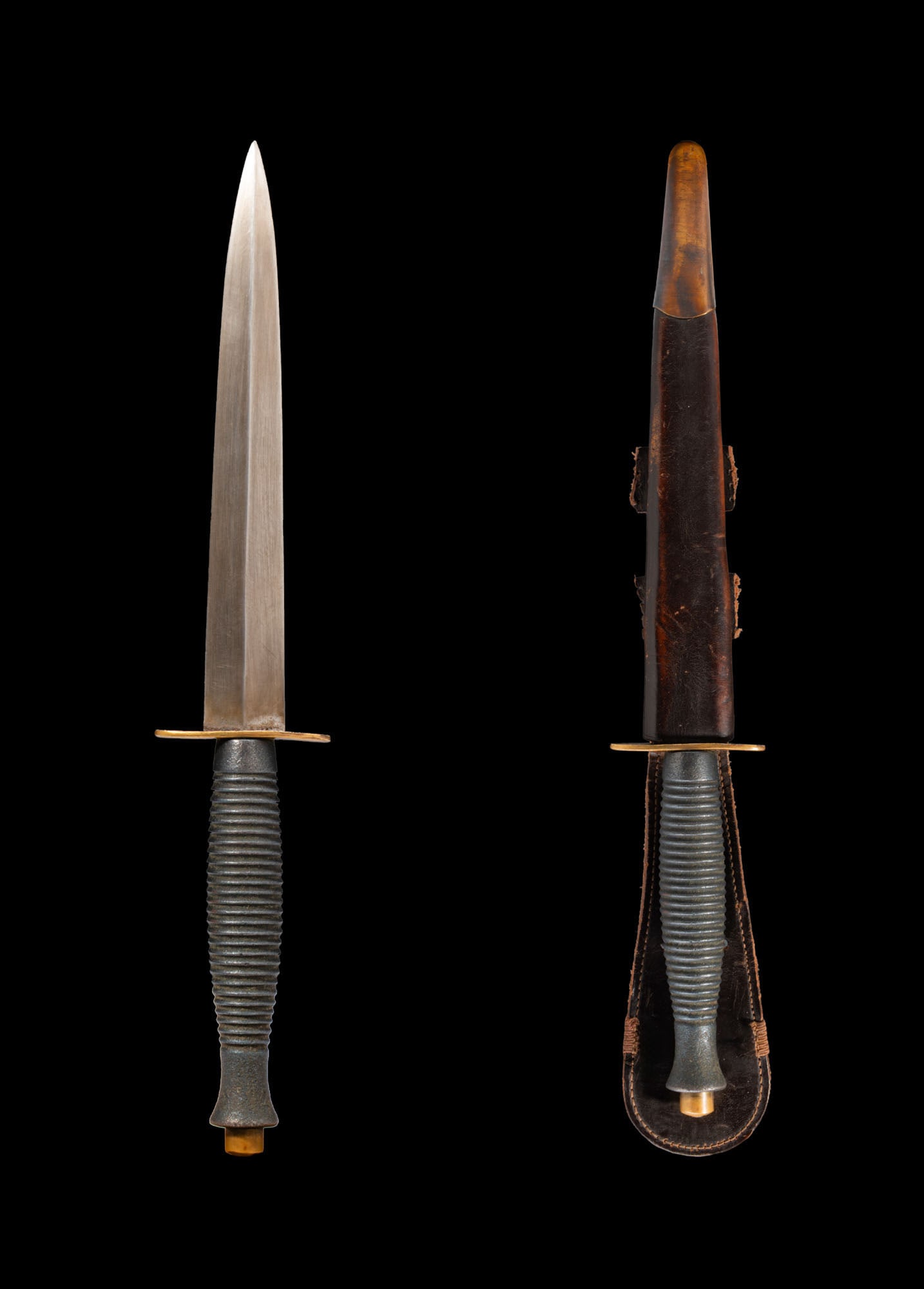 WWII BRITISH THIRD PATTERN FAIRBAIRN SYKES: Ca. AD 1943 - 1945 or later. A third pattern Fairbairn Sykes with leather sheath. This design appeared later in the war and features 27 concentric rings on the cast alloy handle. Possibly post-war. Si