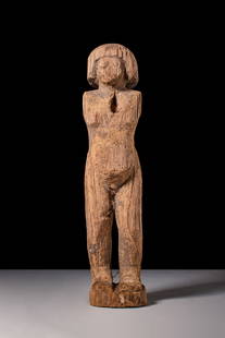 EGYPTIAN WOODEN STATUETTE OF A ROWER: Middle Kingdom, Ca. 2055 - 1790 BC. A carved wooden statuette of a standing rower with a square-cut wig framing a rounded face with incised eyes. The shoulders are broad, each pierced to receive pegge